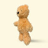 Small Plush Hairy Barry dog toy resembling a teddy bear on a beige background
