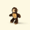 Small Plush monkey dog toy on a beige background