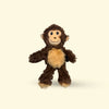 Small Plush monkey dog toy on a beige background
